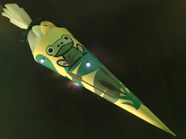 A paper cone with a frog glued to the front